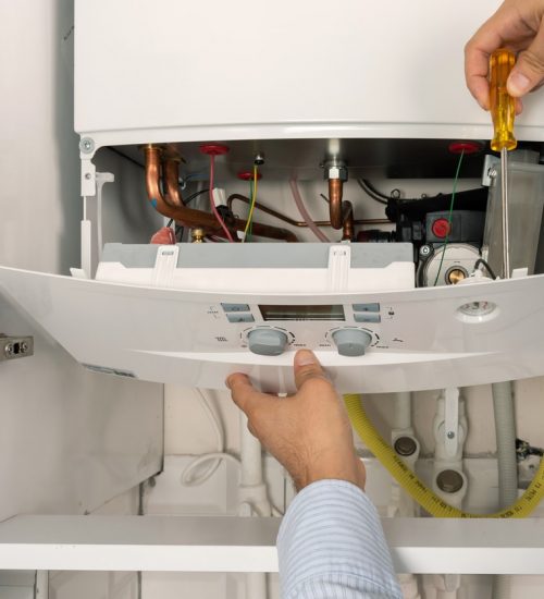 Technician repairing combi Gas Boiler